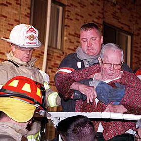 Firefighters aid in evacuation.
